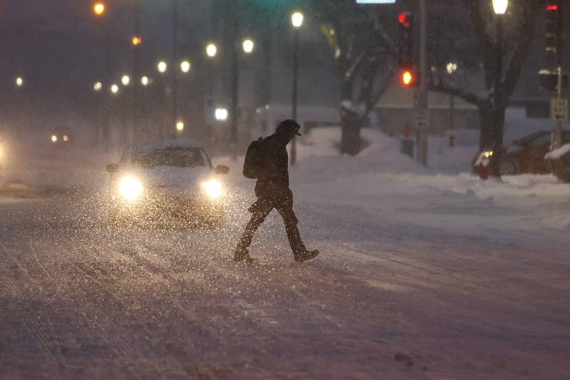 A pedestrian crosses North Joliet Street early Wednesday morning. Wednesday, Feb. 2, 2022, in Joliet.