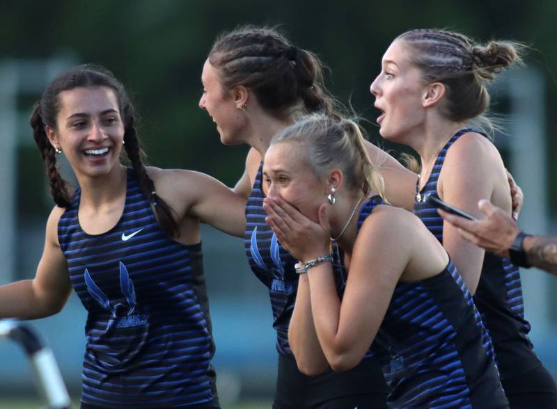 Woodstock’s 800-meter relay team reacts as they learn their time qualified for the state meet in IHSA Class 2A Girls Sectional Track action at Genoa-Kingston School in Genoa on Friday, May 16, 2025.