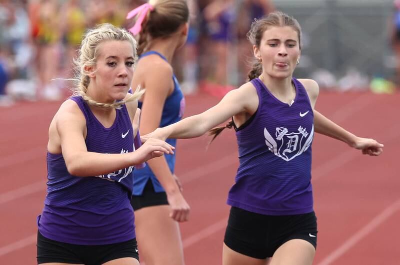 Dixon’s Olivia Arduini hands the baton off to Emma Smith during the 4x800 relay Wednesday, May 8, 2024, during the girls track Class 2A sectional at Rochelle High School.