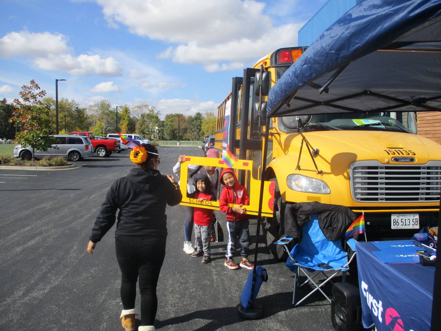 Children pose for a photo at a First Student bus display where the company tried to recruit drivers at Plainfield Pride Fest. Oct. 16, 2022.