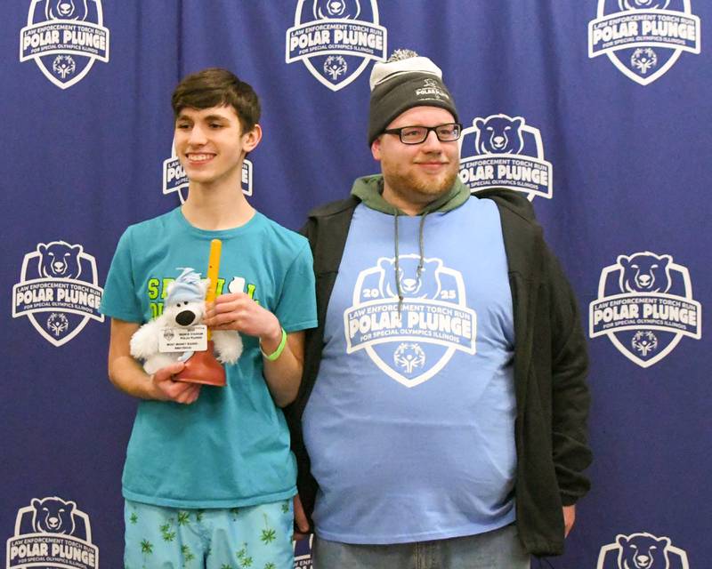 (From left) Aidan Metzl, poses for a photo with volunteer Ryan Keller on Saturday, Feb. 16, 2025, during the 2nd annual Polar Plunge event held at Northern Illinois University's Huskie Stadium.