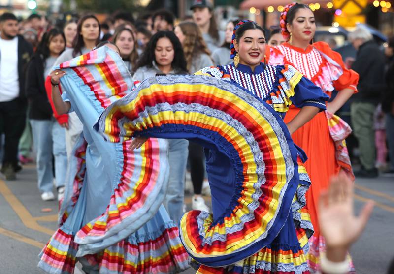 Members of the Northern Illinois University Ballet Folklórico Aztlán perform Thursday, Oct. 17, 2024, in the parade in downtown DeKalb during the Huskie Homecoming Block Party.