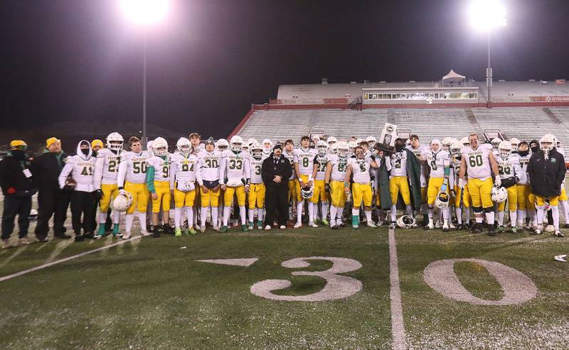 Members of the Providence Catholic football team hoist the Class 5A State runner-up trophy on Tuesday, Dec. 2, 2025 in Hancock Stadium at Illinois State University in Normal.