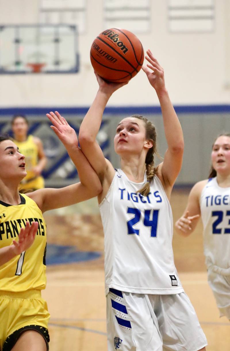 Princeton's Keighley Davis shoots over Putnam County's Ava Hatton in tournament play at Princeton Monday. The Tigresses won 62-36.