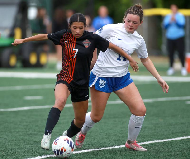 St. Charles East's Mya Leon kicks the ball away from St. Charles North's Francie Phillips during a Class 3A Glenbard West Sectional semifinal game on Tuesday, May 27, 2025 in Glen Ellyn.