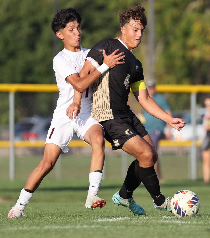 Sycamore's Ethan Royer (right) tries to hold off DeKalb's Mauricio Jasso during their game Tuesday, Oct. 3, 2023, at Sycamore High School.