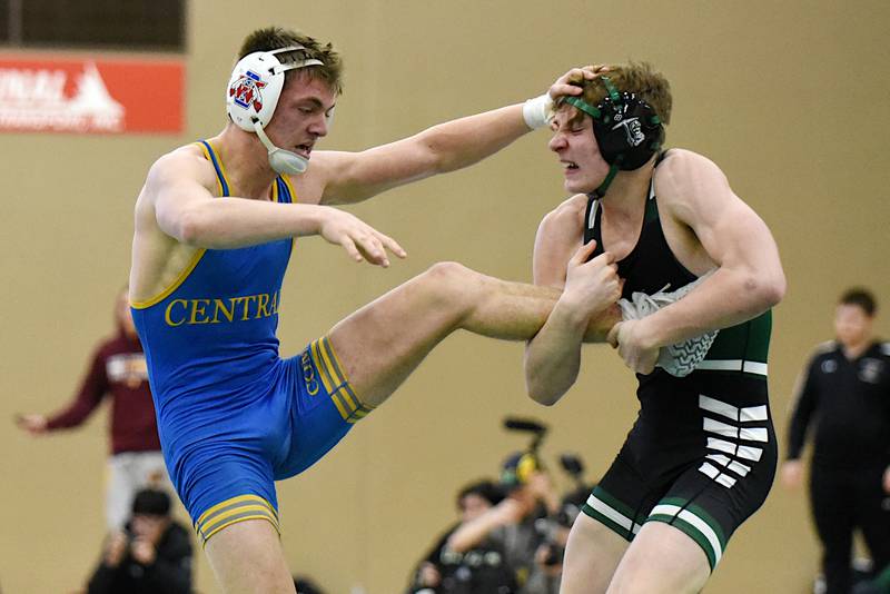 Central-Iroquois West's Evan Cox, left, looks to work out of a single leg takedown attempt from Coal City's Aidan Kenney during the 144-pound championship match at the IHSA Class 1A Coal City Sectional Saturday, Feb. 15, 2025.