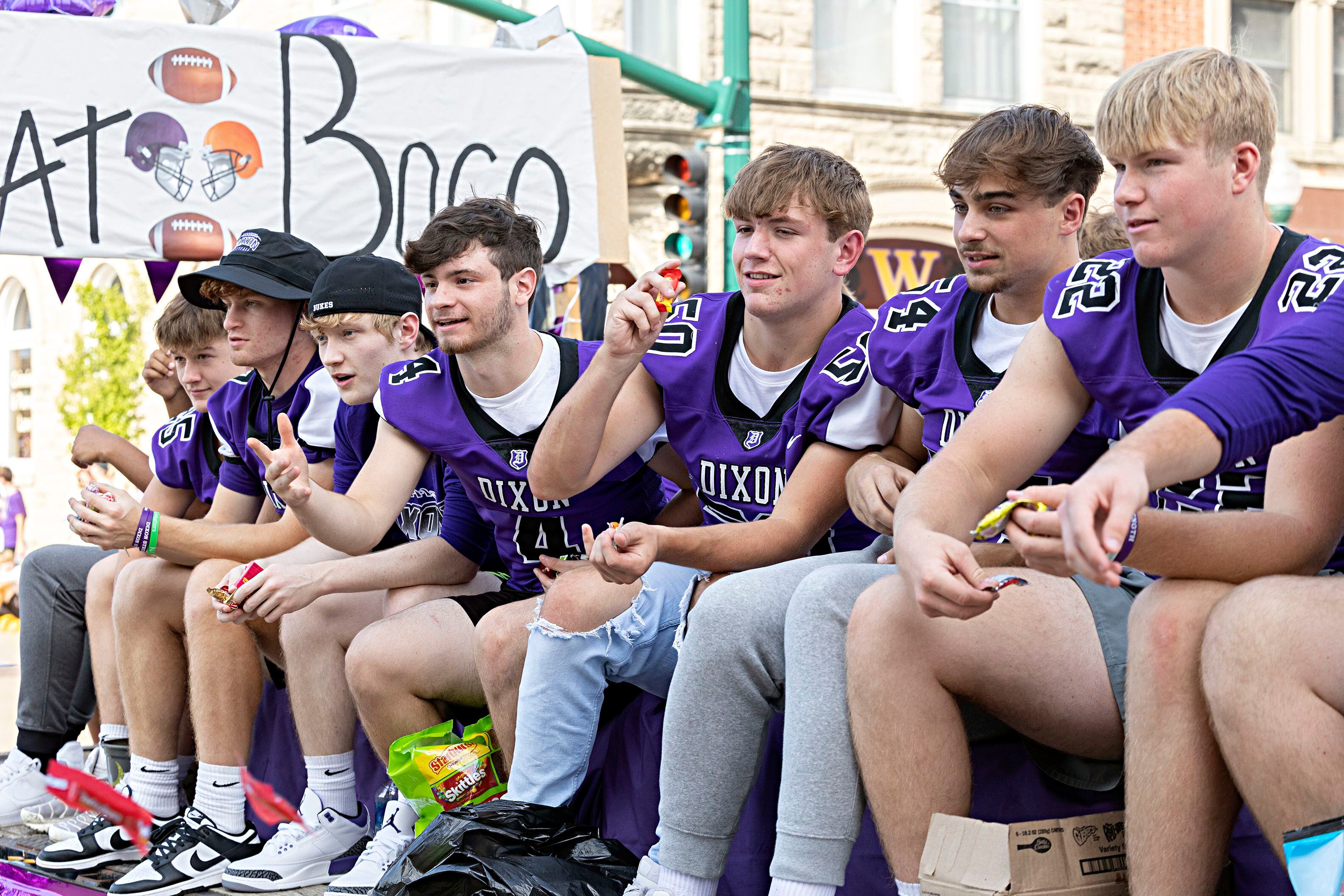 Dixon footballers fire candy from their float Friday, Sept. 29, 2023. The team will take on Winnebago tonight in the homecoming game.