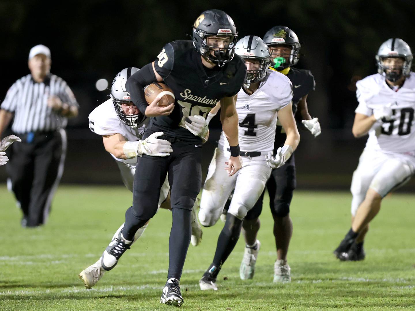 Sycamore's Burke Gautcher tries to pull away from Kaneland's Josh Mauthe during their game Friday, Sept. 29, 2023, at Sycamore High School.