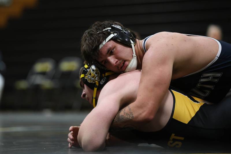 Plainfield South’s Mason Bacon works over Joliet West’s Jacob Tyderek in the 215 pound match Wednesday, Dec. 3, 2025 in Joliet.