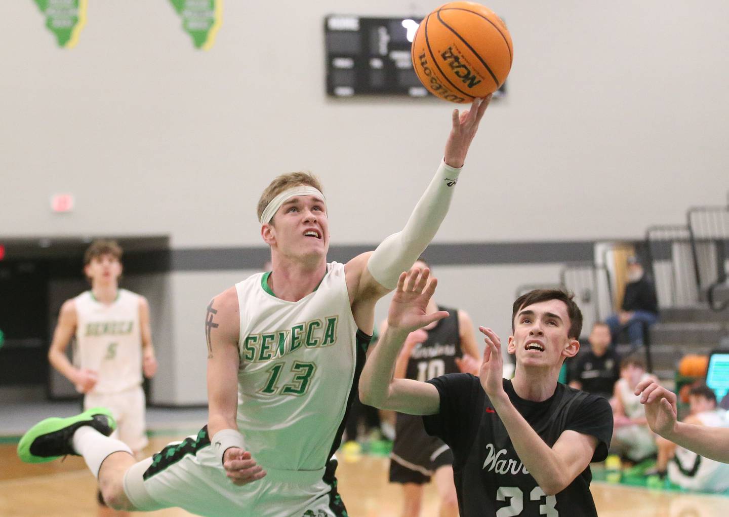 Seneca's Paxton Giertz runs in for a layup over Woodland's Nick Plesko on Friday, Feb. 14, 2025 at Seneca High School.
