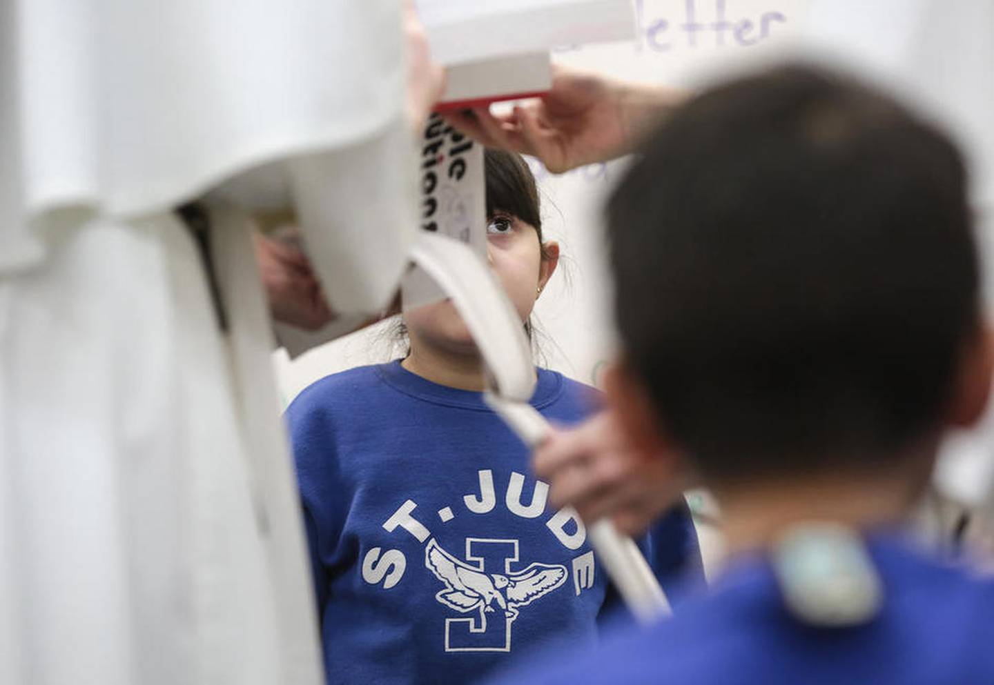 Students listen to Sister Emma Calvo and Sister Cecilia Joseph Dulik during class Thursday at St. Jude Catholic School in Joliet.