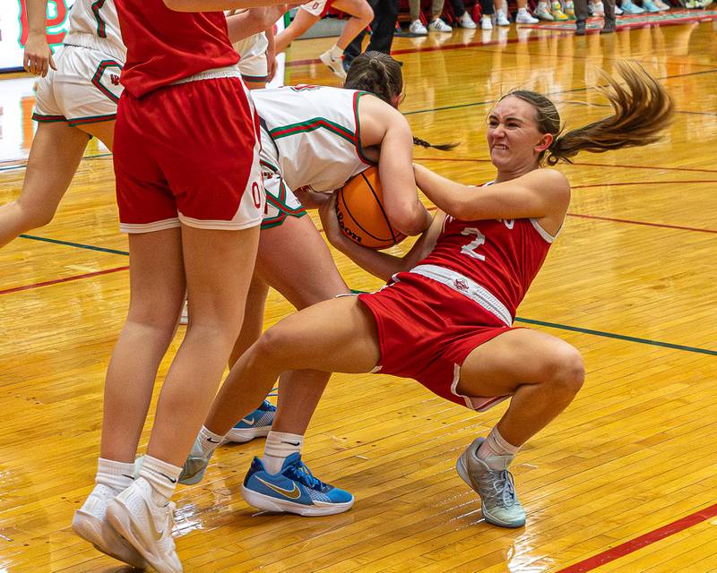 Ashlynn Ganiere (2) of Ottawa and Drew Depenbrock (14) of LaSalle-Peru fight over possession of ball resulting in jump ball on Wednesday, December 17, 2025 at Sellet Gymnasium in LaSalle.