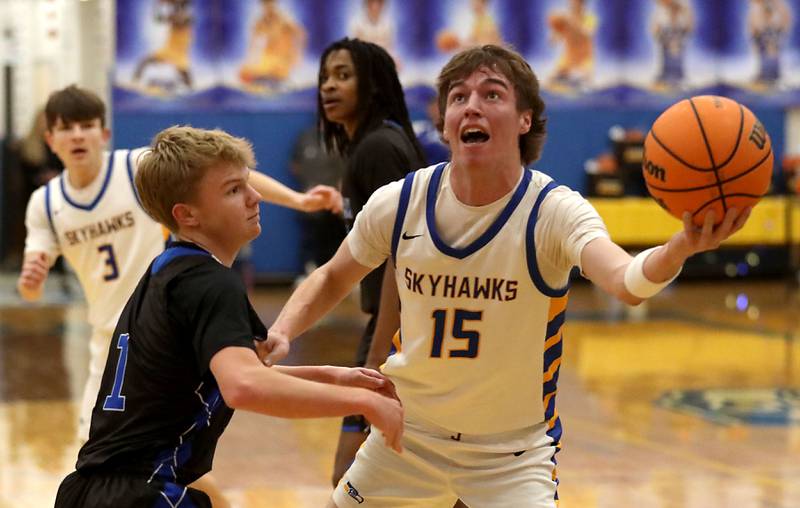 Johnsburg's Ashton Stern shoots the ball over Woodstock's Rian Hahn Clifton during a Kishwaukee River Conference boys basketball game on Friday, February. 13, 2026, at Johnsburg High School.