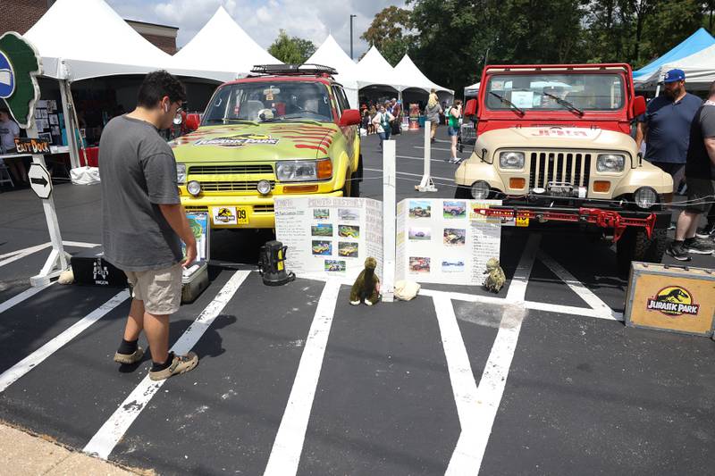 People check out vehicles from Jurassic Park at Comicolopis, Lockport’s 7th annual Comic and Fandom Con on Saturday, July 29.