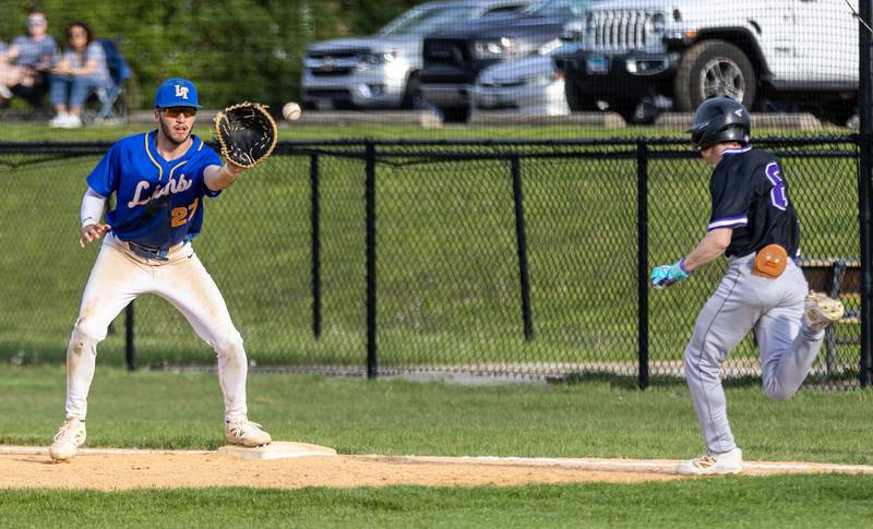 Lyons Township first baseman Dom Pisciotti catches the ball while covering first for an out during a game against Downers Grove North in Downers Grove on Monday, May 12, 2025.