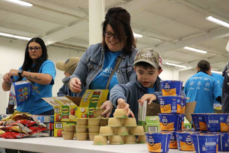 LyondellBasell employees work on packaging food to be sent home with children.