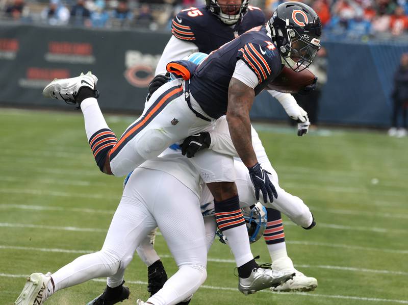 Chicago Bears running back D'Andre Swift hurdles Detroit Lions safety Kerby Joseph during their game Sunday, Dec. 22, 2024, at Soldier Field in Chicago.