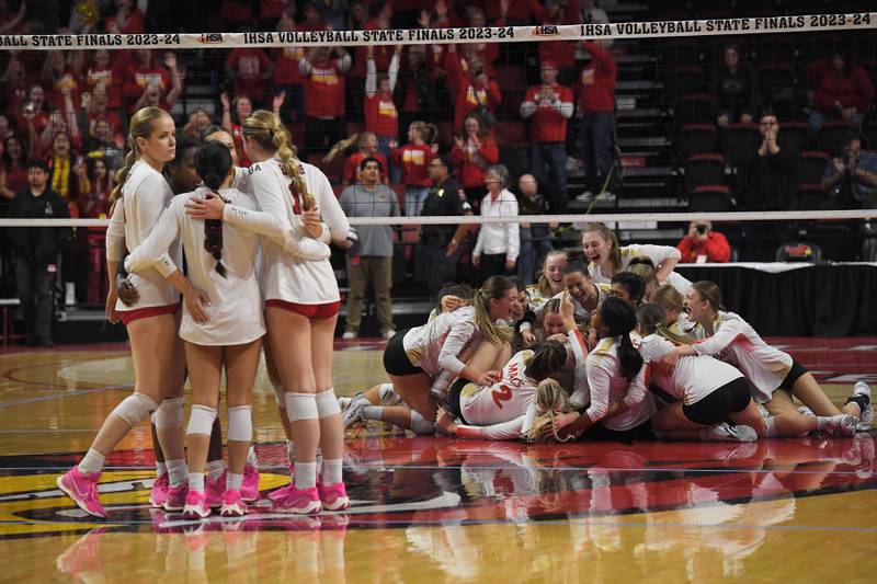 Benet comes together as Mother McAuley celebrates thier win in the Class 4A girls volleyball state championship match at Illinois State University in Normal on Saturday, October 11, 2023.