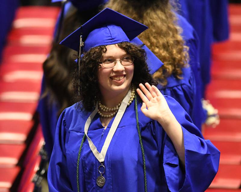 A St. Charles North graduate waves to attendees during the graduation ceremony on Monday, May 18, 2026, held at the NIU Convocation Center in DeKalb.