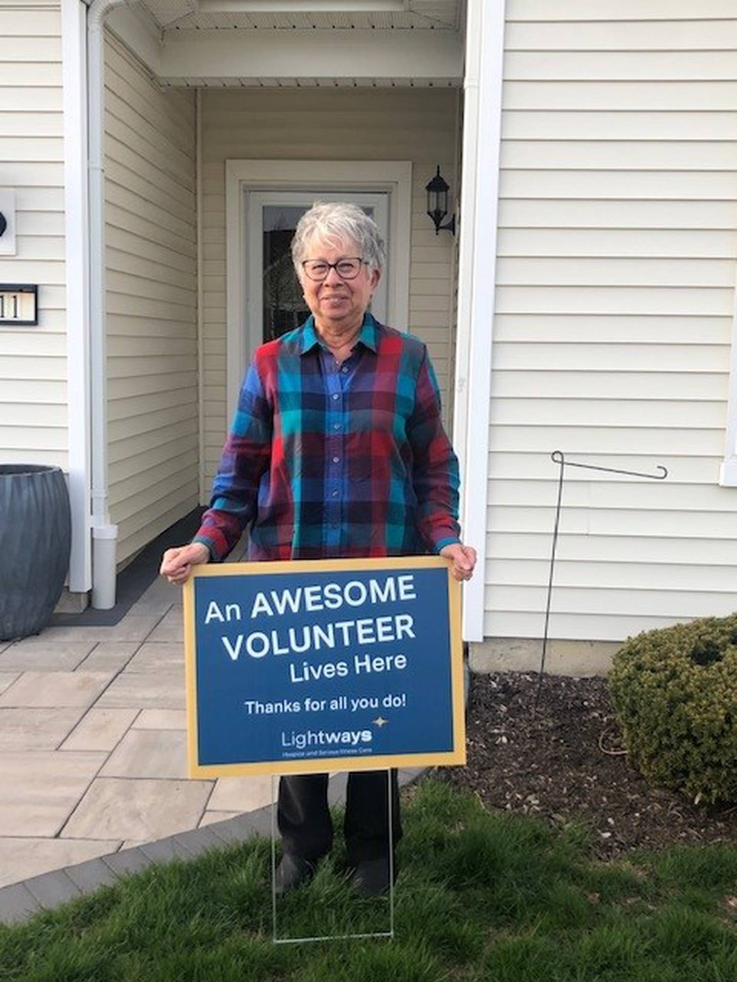 Last week Lightways Hospice and Serious Illness Care in Joliet honored its 120 volunteers by placing signs in the volunteers yards for National Volunteer Appreciation Week 2022. Pictured is Nina Tapella.