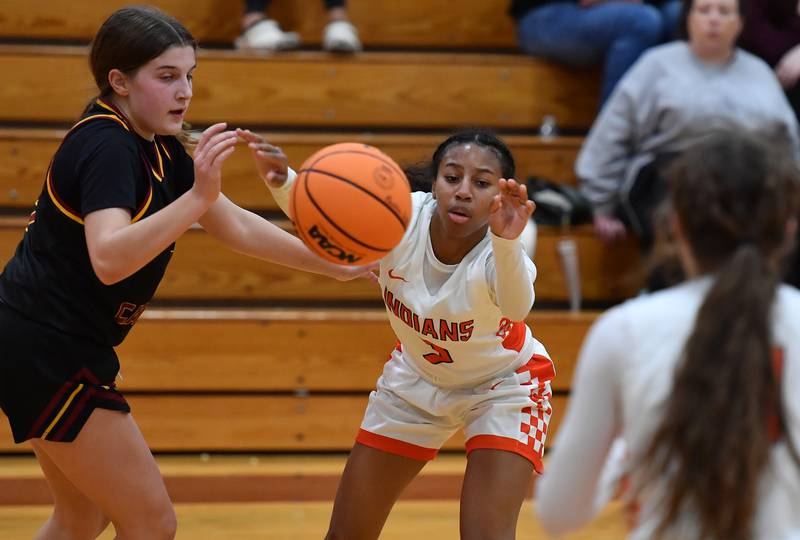 Minooka’s Kendall Thomas passes the ball as Montini’s Kaelyn Zumdahl (left) defends during a Montini Christmas Tournament game on December 22, 2025 at Montini Catholic High School in Lombard.