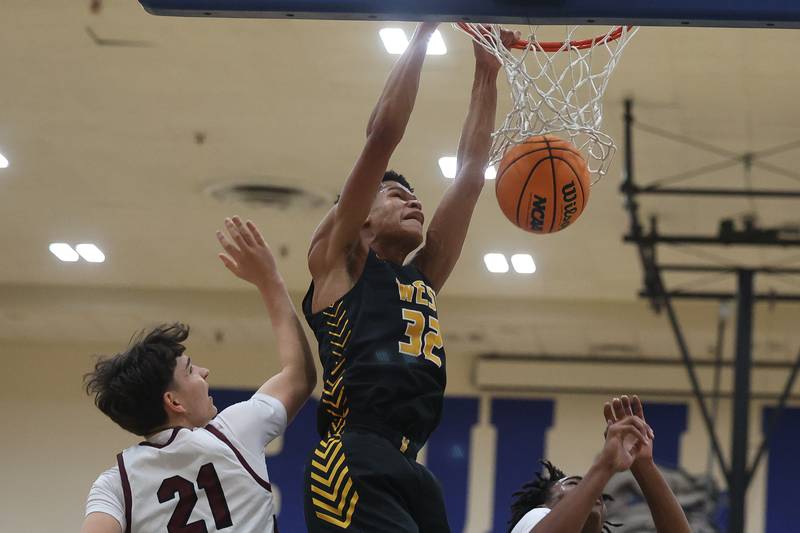 Joliet West’s Ethan Hillman throws down a dunk against Mount Zion in the 2024 Riverside Brookfield Bill VanderMerkt Boys Basketball Tournament on Monday, Nov. 25, 2024 in Brookfield.