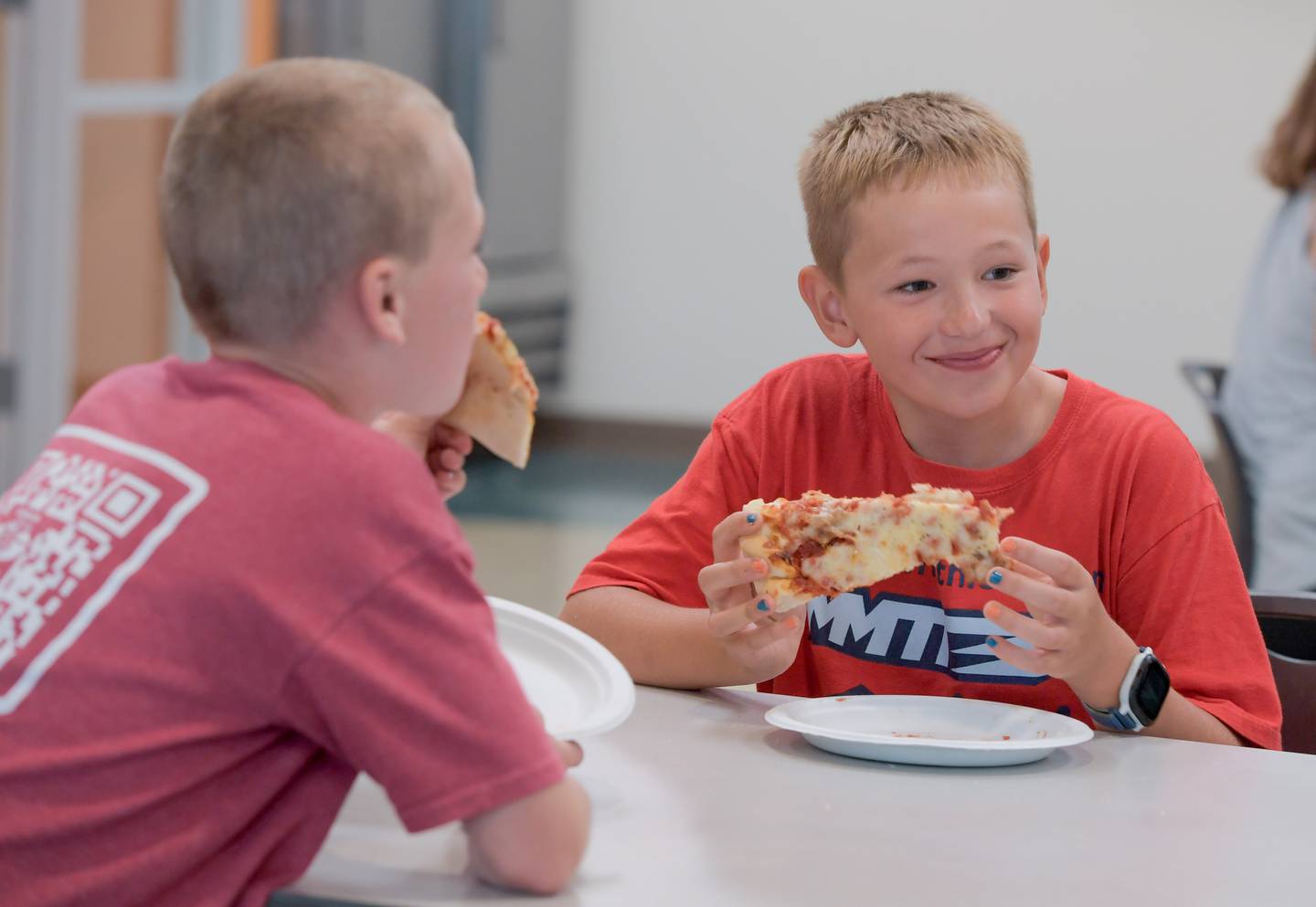 Sean Peterson enjoys some pizza before his 9th birthday party at the Northern Illinois Food Bank in Geneva on Tuesday, September 5, 2023, where he and is friends helped sort and bag up potatoes for distribution.