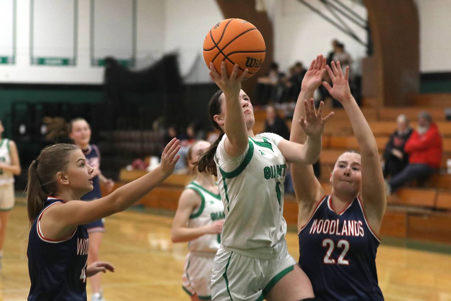 Alden-Hebron's Hayden Smith splits the defense of Woodlands Academy's Emma O'Brien (left) and Morgan Mathy (right) during a nononference girls basketball game on Thursday, Jan. 29, 2026, at Alden-Hebron High School in Hebron.
