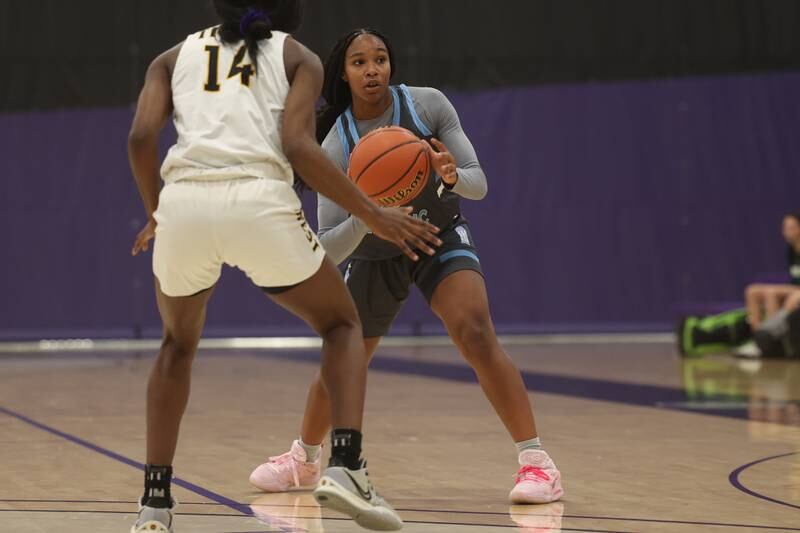 Joliet Catholic’s Layla Pierce looks to pass against Joliet West in the WJOL Basketball Tournament at Joliet Junior College Event Center on Monday