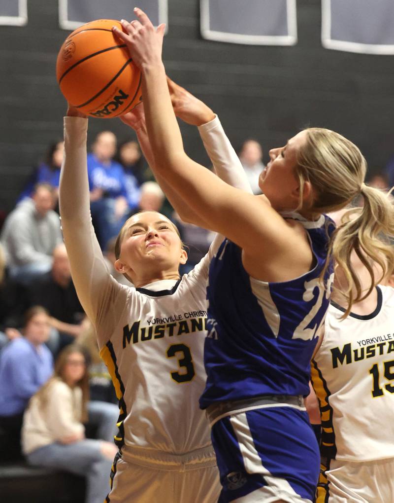 Yorkville Christian's Grace Allgood (left) and Hinckley-Big Rock's Anna Hermann go after a rebound during their Class 1A regional game Tuesday, Feb. 17, 2025, at Indian Creek High School in Shabbona.