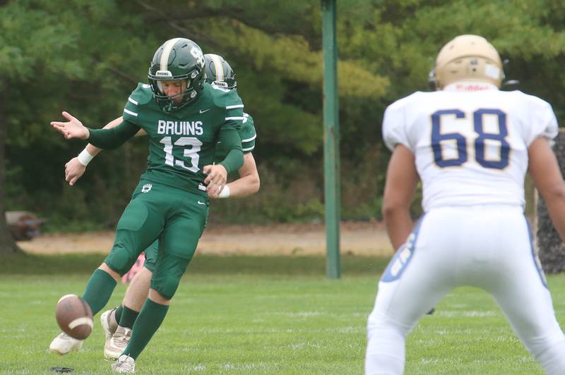 St. Bede kicker Ryan Soliman boots the ball for the opening kickoff as Marquette's Alex Schaefer watches during the Homecoming game on Saturday, Sept. 28, 2024 at St. Bede Academy.