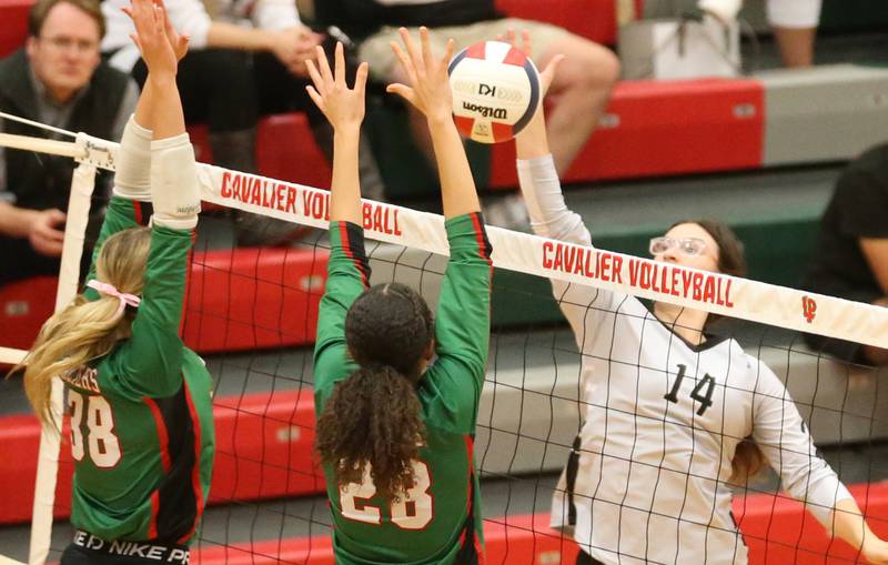 Kaneland's Olivia d'Escoto's spike is blocked by L-P's Aubrey Duttlinger and teammate Ava Currie in AJ Sellett Gymnasium on Thursday, Oct. 24, 2024 at L-P High School.
