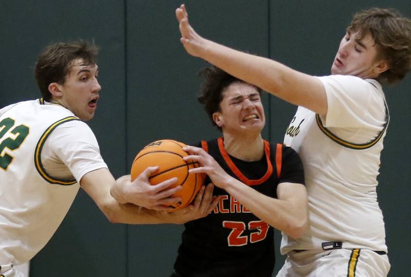 Crystal Lake South's Anthony Santarelli (left) and Ryan Morgan (right) trie to steal the ball from McHenry's Marko Stojich (center) during a Fox Valley Conference basketball game on Friday, Jan. 31, 2025, at Crystal Lake South High School.