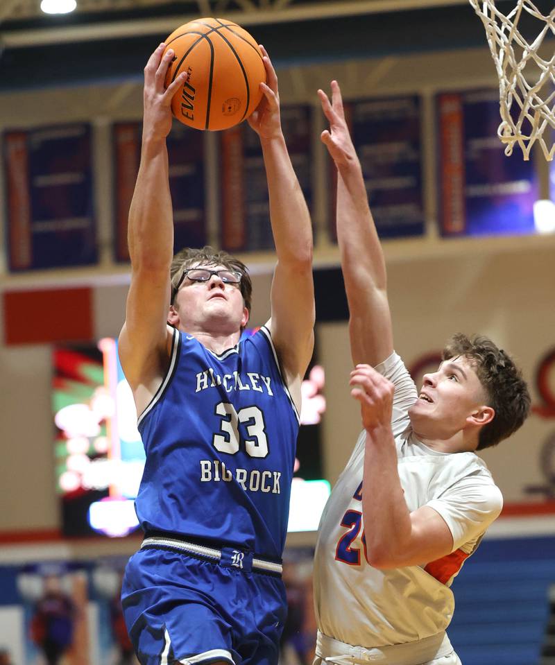 Hinckley-Big Rock's Marshall Ledbetter goes to the basket against Genoa-Kingston's Jaiden Lee Tuesday, Jan. 6, 2026, during their game at Genoa-Kingston High School.