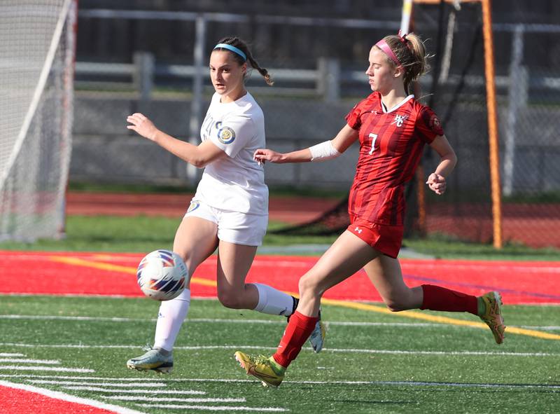 Hinsdale Central's Avery Edgewater (7) chases down the ball against Lyons Township's Caroline McKenna (10) during the girls varsity soccer match between Lyons Township and Hinsdale Central high schools in Hinsdale on Tuesday, April 18, 2023.