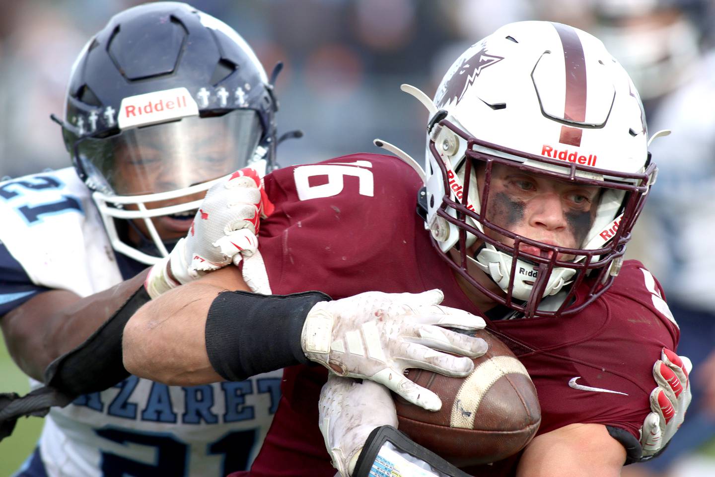 Prairie Ridge’s Dominic Creatore carries the ball against  Nazareth in first-round Class 5A playoff football action at Crystal Lake Saturday.