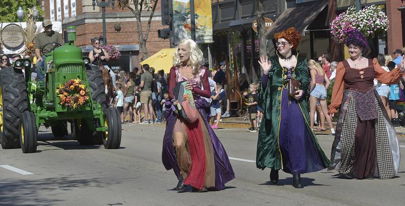 The Sanderson sisters from the movie "Hocus Pocus" toss out candy treats preceding the McDonnell Farms tractor Sunday, Oct. 1, 2023, during the Fall Festival Parade in Ottawa.