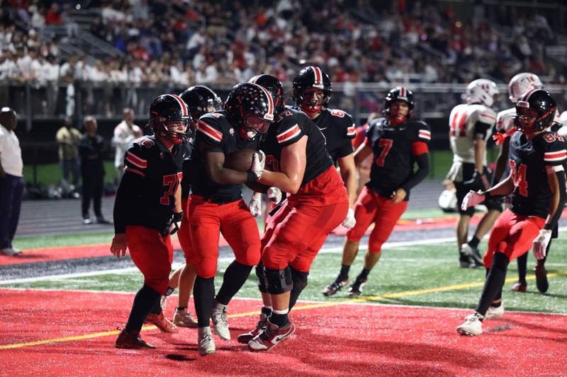 Lincoln-Way Central players rush to celebrate a touchdown by Justin Cobbs during the Knight's 28-20 victory over Bradley-Bourbonnais on Friday, Oct. 3, 2025.