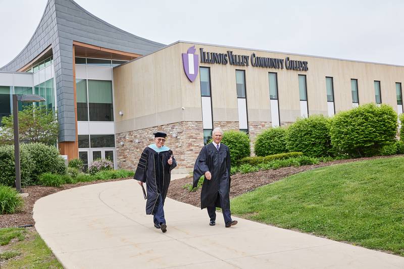 Illinois Valley Community College President Jerry Corcoran heads to his final commencement as IVCC president accompanied by IVCC Board of Trustee Chair Everett Solon.