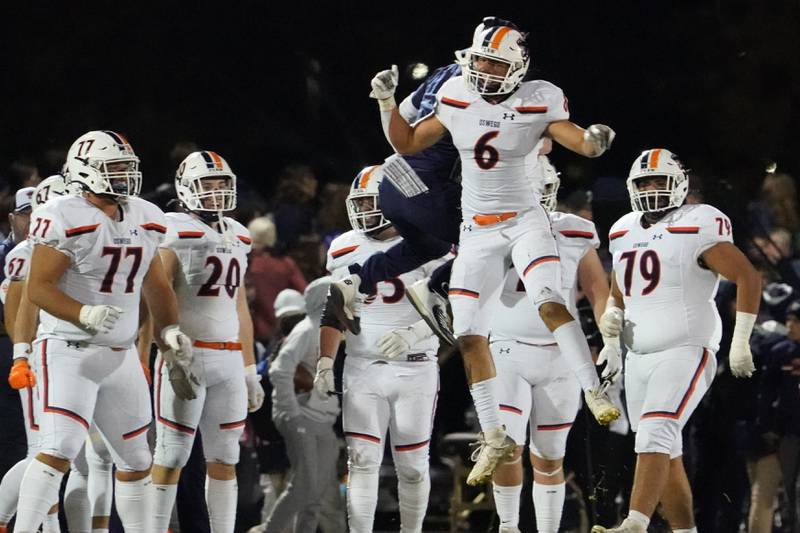 Oswego’s Mikey Claycombe (6) celebrates on the sidelines after forcing fumble on a sack against Oswego East's Niko Villacci (not pictured) during a football game at Oswego East High School on Friday, October 25, 2024.