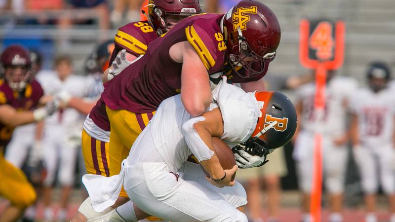 Loyola lineman Brooks Bahr sacks Rochester quarterback Hank Beatty during the second quarter Sept. 4 in Wilmette.