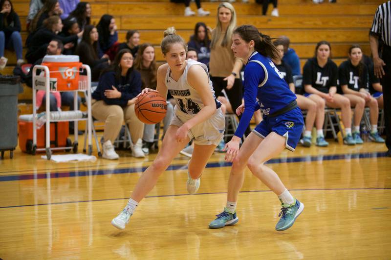 Downers Grove South's Allison Jarvis drives the baseline against LyonsLillian Prendergast at the West Suburban Conference Crossover Championship on Wednesday, Feb.8,2023 in Addison.