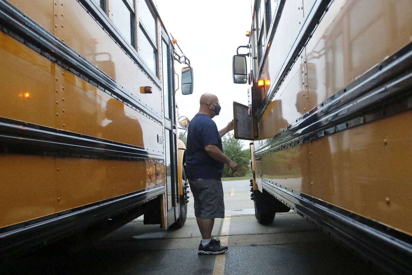 Woodstock Community Unit School District 200 school bus driver Bill Chrisos performs a routine pre-route safety check on his vehicle prior to leaving to pick students up for school on Tuesday, Oct. 5, 2021, in Woodstock.