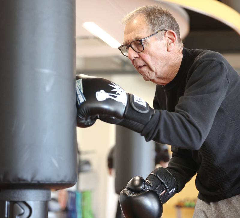 Peter Schram hits the bag Friday, April 28, 2023, during Rock Steady Boxing for Parkinson's Disease class at Northwestern Medicine Kishwaukee Health & Wellness Center in DeKalb. The class helps people with Parkinson’s Disease maintain their strength, agility and balance.