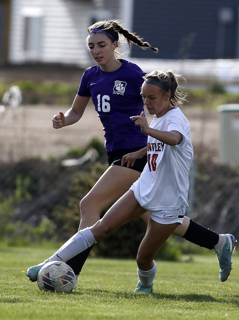 Huntley's Maddie Cummings controls the ball as she is defended by Hampshire's Shayne Norris during a Fox Valley Conference soccer game on Tuesday, April 23, 2024, at Hampshire High School.