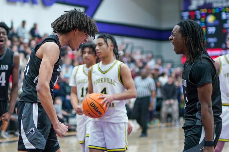 Kaneland’s Evan Frieders (11) and Kaneland's Marshawn Cocroft (3) react after Frieders scores a basket on a Yorkville Christian foul during a championship final basketball game in the 61st annual Plano Christmas Classic at Plano High School on Saturday, December 28, 2024.