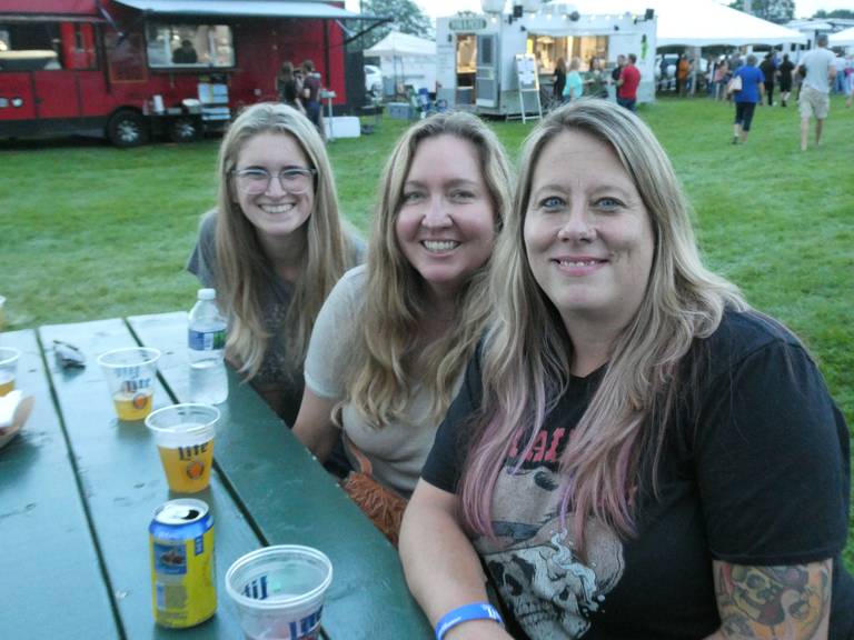 These three women say that high grocery prices and local bar and restaurant business closures haven't stopped them from going out to events like McHenry's Blues and Brews Fest on Aug. 20, 2022. From left to right: Sadi Brahar of Crystal Lake, Lynnet Koomas from San Jose, CA, and Dawn Lasorso from Wonder Lake.