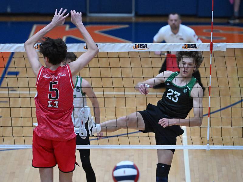 York's Jack Bute (23) watches his hit for a point past Marist's Ethan Kuziela during the IHSA state boys volleyball championship match on Saturday, June 1, 2024 in Hoffman Estates.