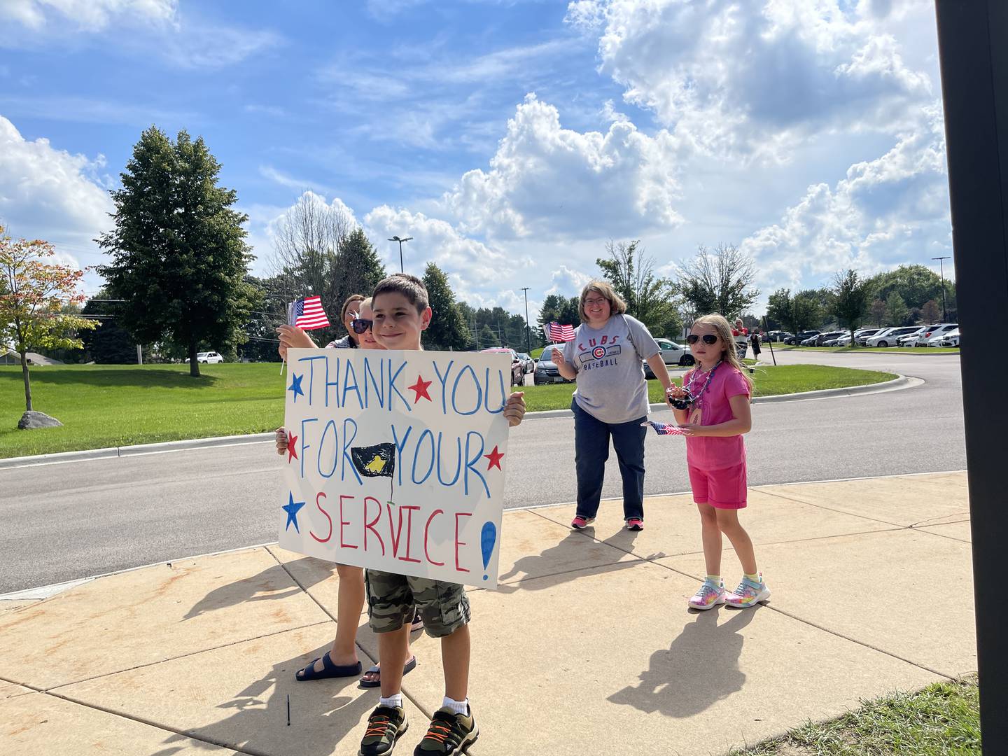 Families and children stand ready to welcome more than 50 veterans on Sunday, Aug. 28, 2022, at McHenry High School.